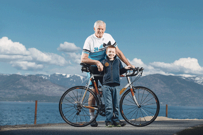 Cystonisis grandson and his grandfather pose with bike