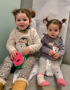 Nora and Kayla, who have Shwachman-Diamond syndrome, at a hematology appointment