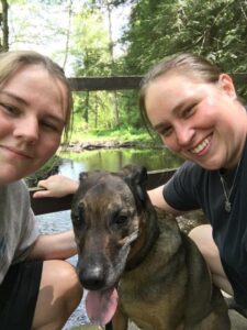 Kyla, who has Gleich syndrome, with her dog and her fiance.