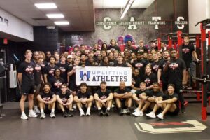 The Davidson football team stands with a Lift for Life poster after completing this rare disease initiative from Uplifting Athletes