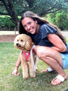 Gabby Zeppieri smiles at the camera with her dog. Gabby is the only known person with NLSD-M in the US.